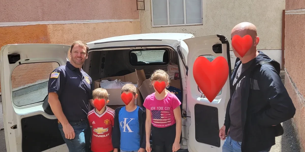 Group photo with van and supplies for Ukraine